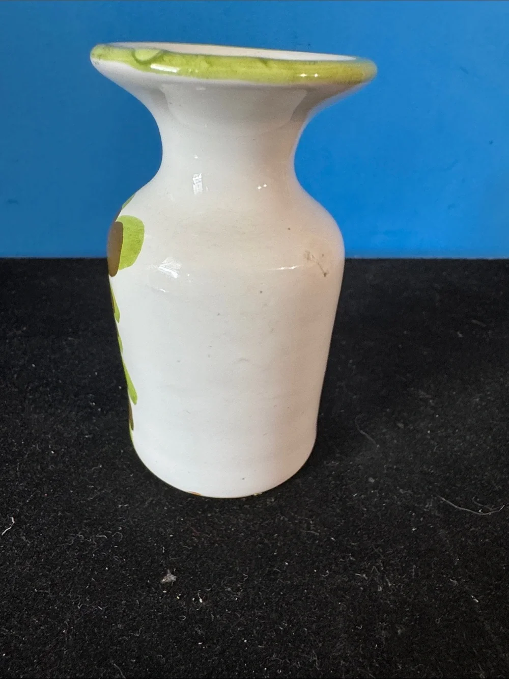 vintage ceramic vase features hand-painted floral motifs typical of mid-century